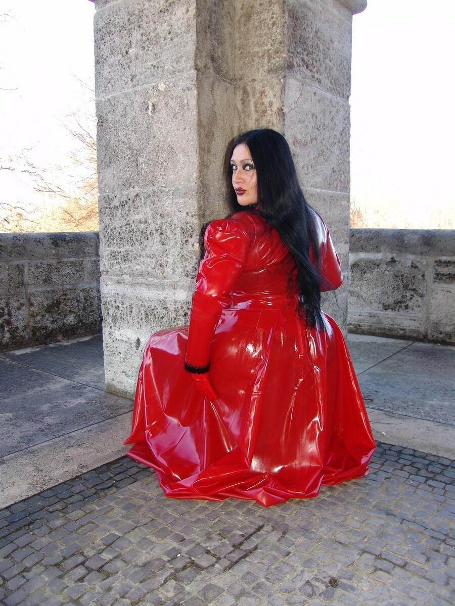 Busty Brunette Looks Gorgeous In Red Latex Dress Photos