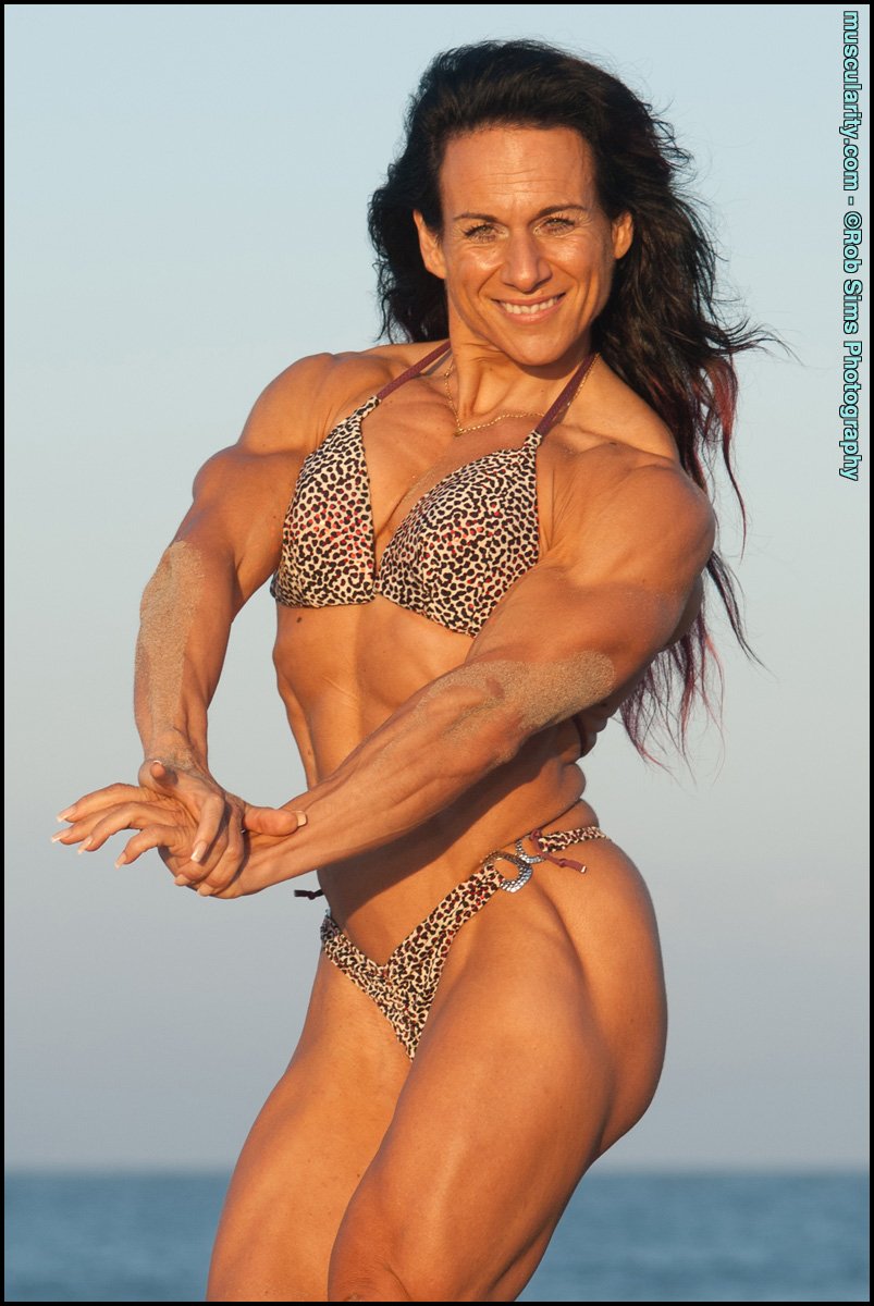 Muscular Milf Caroline Gaume Has Fun Showing Muscles At The Beach In Bikini Photos