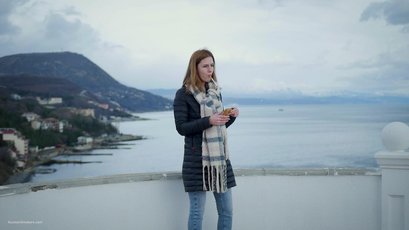 Russian babe with scarf smoking a cigarette by the river — 2