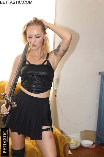 Sweet blonde girl holds a big sword while posing in a black outfit - 000002