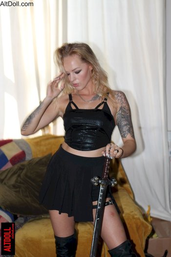 Stunning blonde chick playing with a big sword and posing - 000001