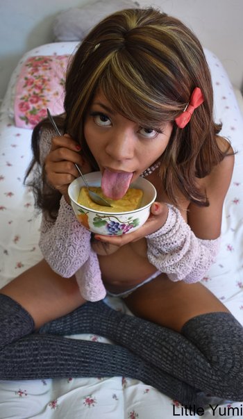 Lovely Little Yumi showing her tits while eating a pie