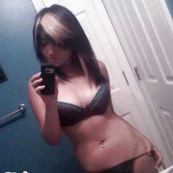 Asian babe in the mirror showing off huge boobs