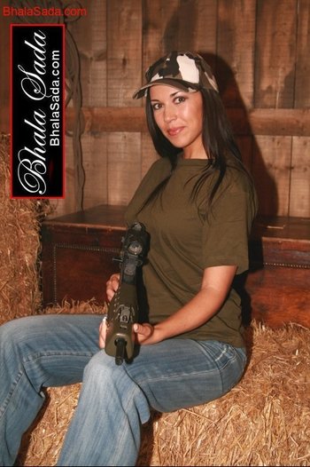 Stunning brunette chick loves posing with a big gun - 000005