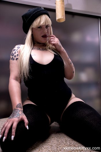 Tattooed babe Slutty Natasha poses in and out  her seductive bodysuit