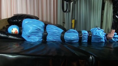 Submissive girl gets wrapped in a blue latex — 11