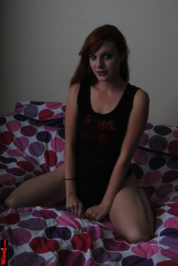 Redhead cutie showing off her long legs while posing in a black shirt - Redhead cutie showing off her long legs while posing in a black shirt 010