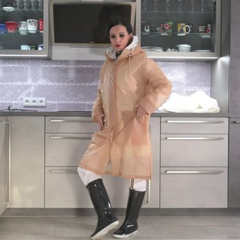 Woman in the kitchen wearing two layers of schmuddelwedda over a rain suit