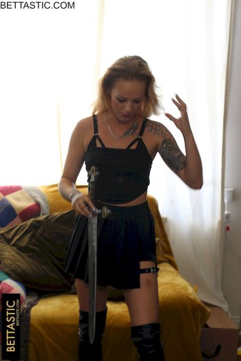 Hot tattooed chick wears a sexy black outfit while posing with a sword - 000014