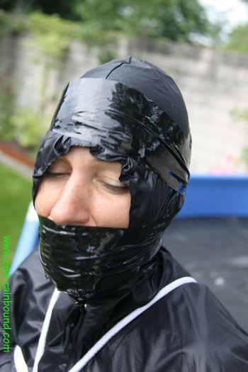 Chick being bound tightly hooded and gagged in her shiny nylon rainwear - SNA-Rainbound-Nylon (10)