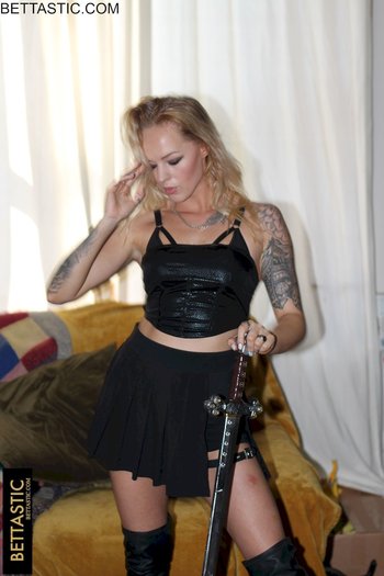 Sweet blonde girl holds a big sword while posing in a black outfit - 000009