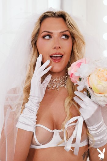 Sexy bride Savvy Suxx does not mind showing her shaved pussy