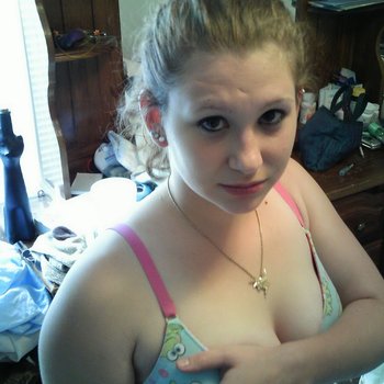 Busty babe looks naughty on her back showing boobs
