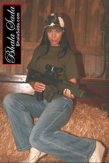 Stunning brunette chick loves posing with a big gun - 000009