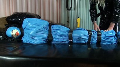 Submissive girl gets wrapped in a blue latex — 8