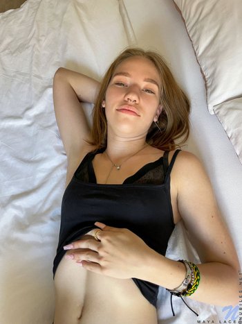 Solo Maya Sinn gently fingering her shaved pussy on the bed 002