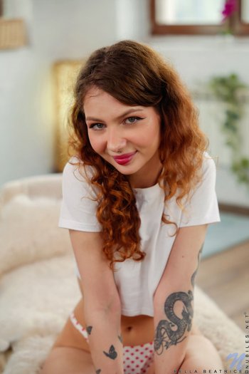 Solo Bella Beatrice with small tits and shaved pussy posing naked