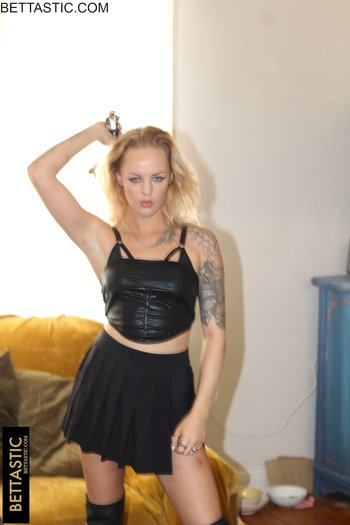 Sweet blonde girl holds a big sword while posing in a black outfit - 000001