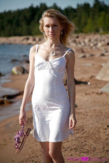Lovely young girl Mariana strips and shows her shaved pussy on the beach