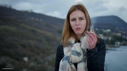 Russian babe with scarf smoking a cigarette by the river — 4