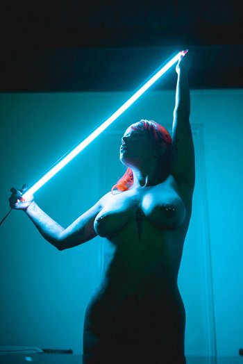 Redhead chick with tattoos puts her naked body on display - 000001