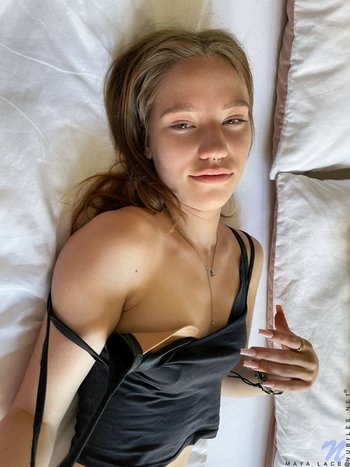 Solo Maya Sinn gently fingering her shaved pussy on the bed 003