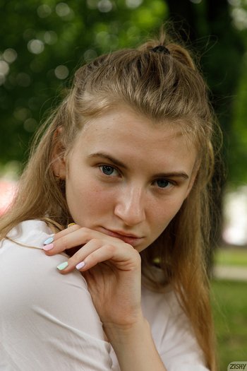 Regan Budimir poses outdoors wearing a red skirt - Regan-Budimir-Panties%20(4)