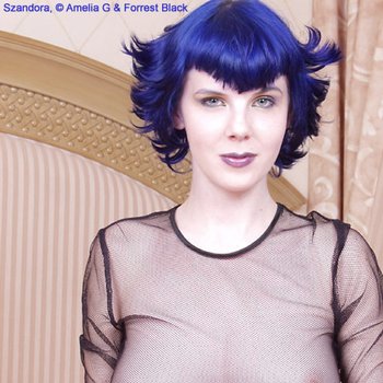 Blue haired Szandora posing in see through lace Dress