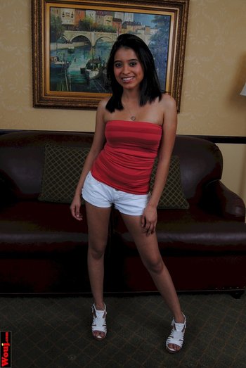Brunette cutie posing in white shorts and a red shirt - 000004