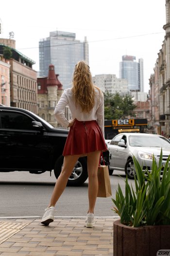 Regan Budimir poses outdoors wearing a red skirt - Regan-Budimir-Panties%20(1)